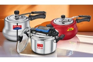 Three Prestige pressure cookers in silver, red, and white colors, displayed on a kitchen counter.