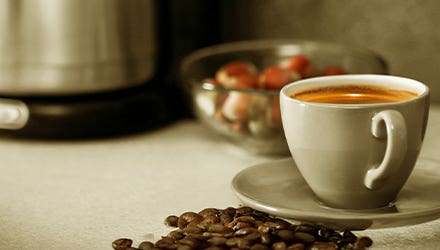 Cup of Freshly Brewed Coffee with Coffee Beans