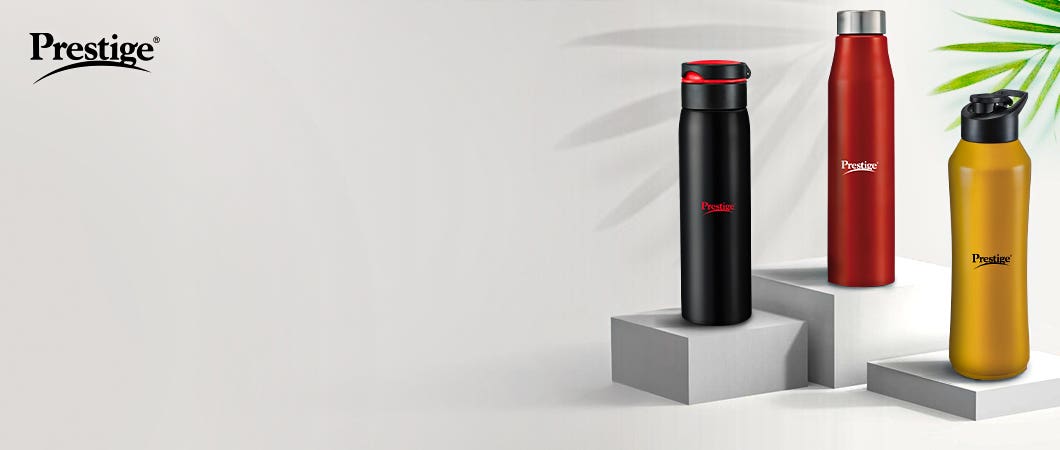 Three TTK Prestige reusable water bottles (black, red, and gold)