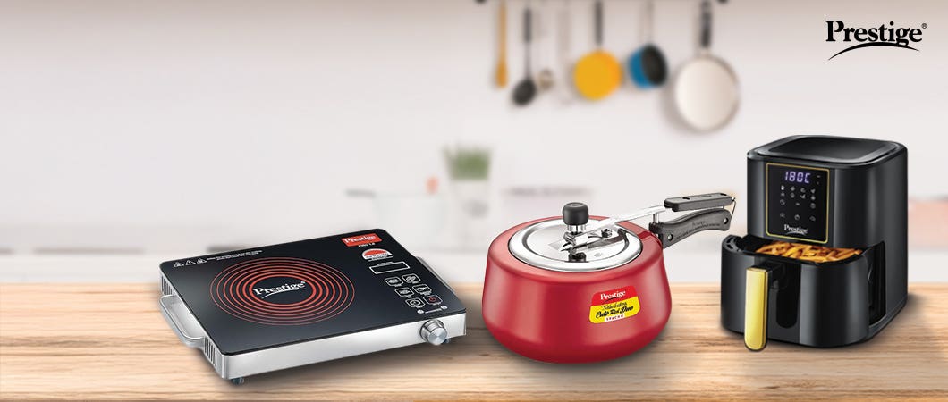 Prestige kitchen appliances including an induction cooktop, pressure cooker, and air fryer displayed as essentials