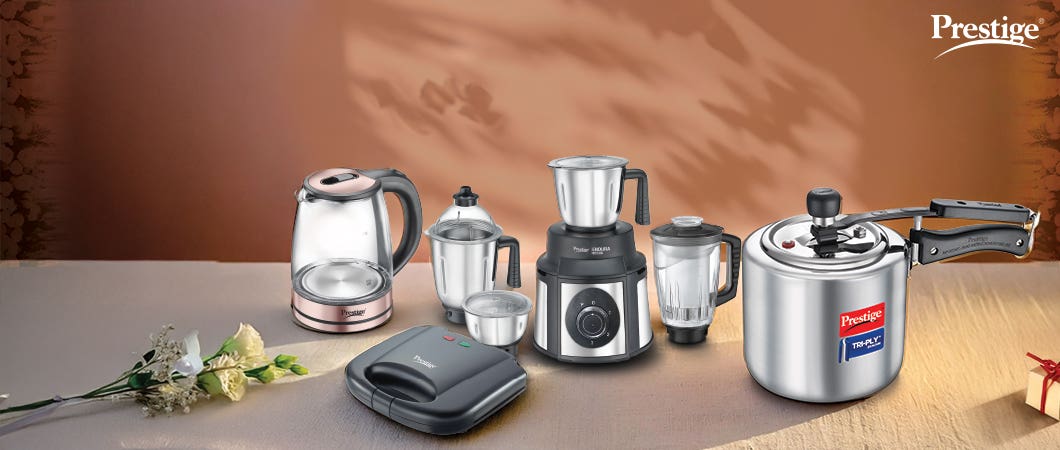 Prestige kitchen appliances including a kettle, blender, mixer, sandwich maker, and pressure cooker displayed as perfect wedding gifts for newlyweds.