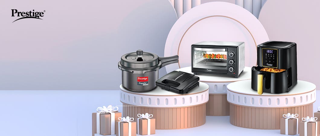 Prestige kitchen appliances including a pressure cooker, oven, sandwich maker, and air fryer, displayed