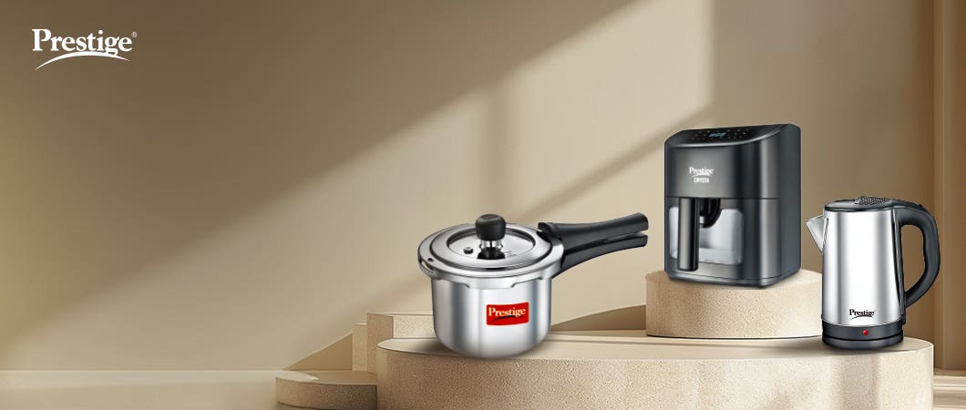 Prestige kitchen appliances, featuring a stainless steel pressure cooker, air fryer, and kettle, displayed in a modern setup for essential home cooking in 2025.